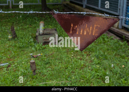 Warning sign for landmines in the reproduction of a minefield at the Sarajevo Tunnel Museum housing the 1993 underground tunnel built during the Siege Stock Photo