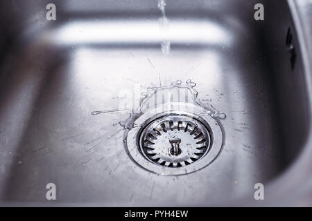 Water running from tap to kitchen sink. Fresh water saving concept Stock Photo