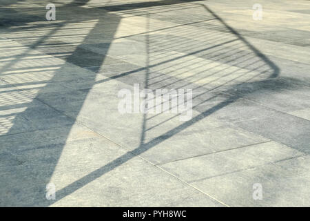 on the floor the sun's rays. The Shine of sunlight on pressed Sandstone paving slabs is an unusual perspective of photo paving slabs with a small depth of field in perspective. Stock Photo