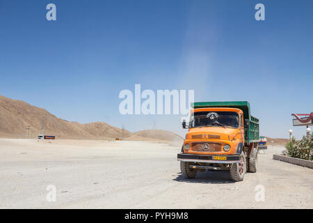 YAZD, IRAN - AUGUST 17, 2016: Old Iranian Dump Truck standing on a highway parking lot near Yazd, in the middle of the desert, on the road connecting  Stock Photo