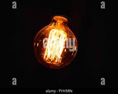 vintage lightbulb with dust on it against  dark background Stock Photo