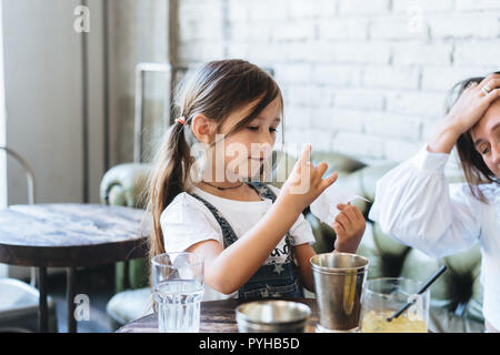 Little girl holding a check in her hands Stock Photo
