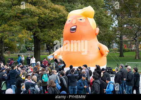 A balloon of Donald Trump seen during the rally. Hundreds of Anti DOnald Trump demonstrators gather at Battery Park for a rally in New York City calling for the impeachment of President Trump, they were met with a few Trump supporters hosting a counter protest, Stock Photo