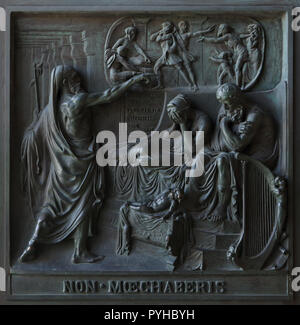 Thou shalt not commit adultery. Bronze bas relief by French sculptor Henri de Triqueti with assistance from Etienne Hippolyte Maindron (1834-1841) on the main doors of the Madeleine Church (Église de la Madeleine) in Paris, France. The Old Testament story of King David, seated beside Bathsheba, overcomed with remorse as the stern prophet Nathan confronts him are depicted to illustrate one of the Ten Commandments. Stock Photo