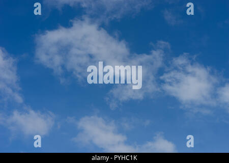 Blue sky with drifting fluffy white clouds Stock Photo