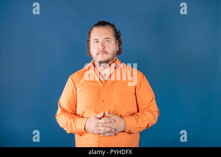 Sad fat man posing in the studio. Health problems. Excess weight Stock Photo
