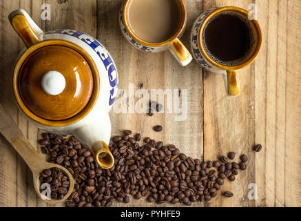 Coffee background with vintage coffee pot, mugs and coffee beans on rustic wooden table - Top view photo with space for text Stock Photo