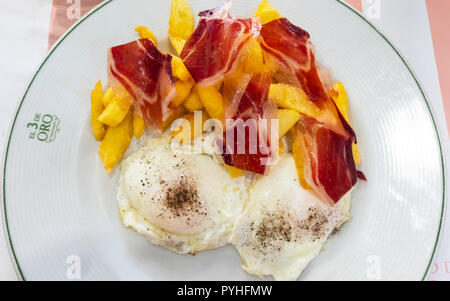 Ham and eggs with fries, Seville style Stock Photo