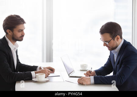 Two men in suits are meeting in the office Stock Photo