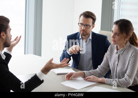 Two hr managers listen attentively to candidate for vacancy. Stock Photo