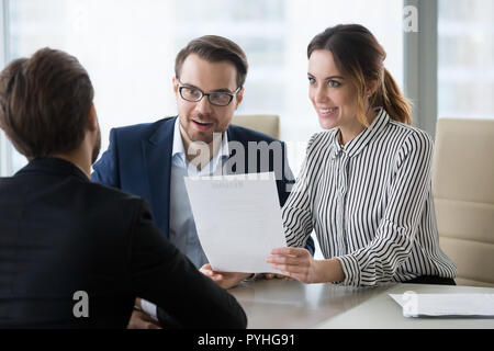 Two hr managers smiling and looking at applicant. Stock Photo