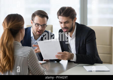 Pleasantly surprised hr managers reading resume of applicant. Stock Photo