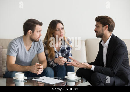 Young couple, family at meeting with realtor, interior designer Stock Photo