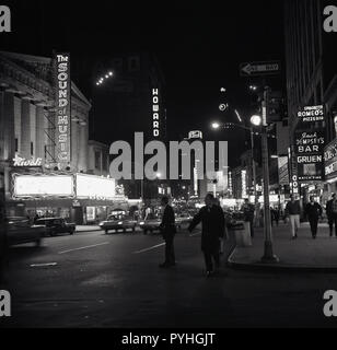 1959, historical, nightime on Broadway, midtown Manhattan and the neon lights showing the bars and restaurants and the original production of The Sound of Music, a musical by Rodgers and Hammerstein, based on the memoir of Maria von Trapp, staring Mary Martin and Theodore Bikel. On the right is Jack Dempsey's, the bar and restaurant owned by the former world Heavyweight boxing champion and a cultural icon of the 1920s. Stock Photo