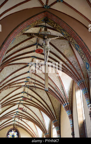 Crucifix, galeri hats and Papal tiara in Gothic Archcathedral Basilica of the Assumption of the Blessed Virgin Mary and Saint Andrew, Frombork Cathedr Stock Photo