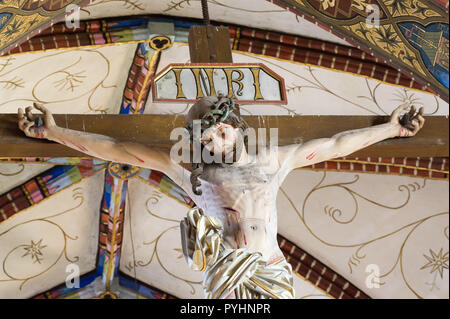Crucifix and galeri hats in Gothic Archcathedral Basilica of the Assumption of the Blessed Virgin Mary and Saint Andrew, Frombork Cathedral, on Cathed Stock Photo