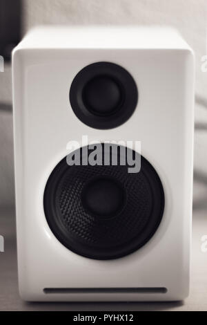 monochrome close up of a white piano lacquer desktop speaker, design Stock Photo