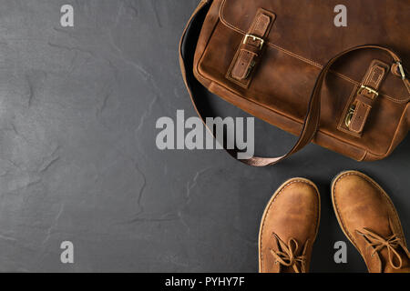 Leather Vintage business bag and leatrher Casual Shoes on black stone background with copy space, accessories costume concept Stock Photo