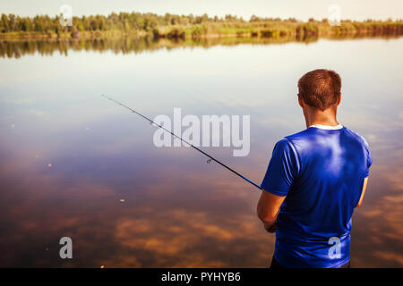 bank fishing. fisherman with spinning rod at sunset. copy space Stock Photo  - Alamy