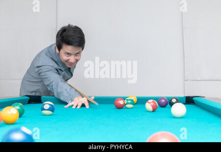 Asian man playing billards, sport and recreation concept Stock Photo