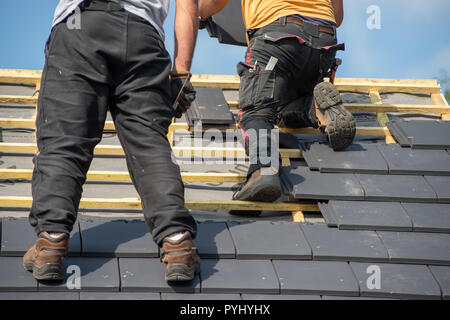 two carpenters working on the roof Stock Photo