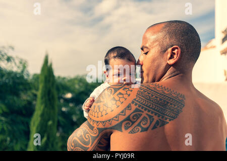A 7 week old baby boy over the shoulder of his dad. Stock Photo