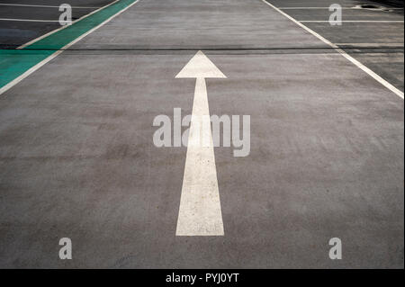 white arrow painted on the road Stock Photo