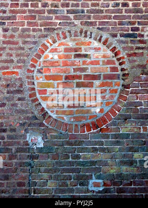 Bricked up round window opening using contrasting red bricks in Bawtry South Yorkshire England Stock Photo
