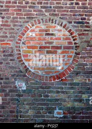 Bricked up round window opening using contrasting red bricks in Bawtry South Yorkshire England Stock Photo