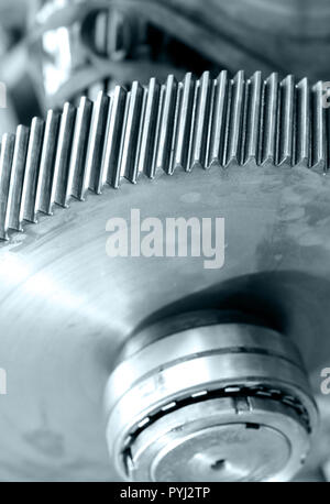 cogwheel of a helical gear in a gearbox, detail of the teeth with a red mark, black and white photo with bluish tone Stock Photo