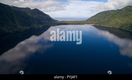 Clouds reflected in the calm sea of Slight Bay, in Aysén. South of Chile Stock Photo