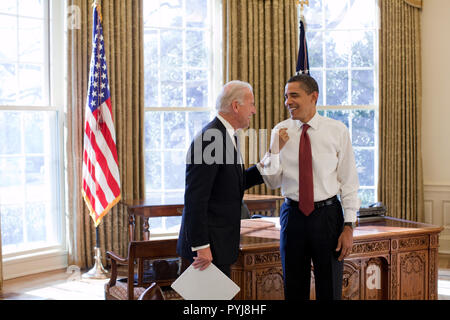 President Barack Obama and Vice President Joe Biden laugh together in the Oval Office, 1/22/09. Stock Photo