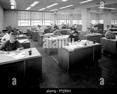 The staff of female computers at work in the 8- by 6-Foot Supersonic Wind Tunnel at the National Advisory Committee for Aeronautics (NACA) Lewis Flight Propulsion Laboratory. The lab’s Computer Section occupied three offices on the second story of the office building at the 8- by 6 facility. The largest office, seen in this photograph, contained approximately 35 women with advanced mathematical skills, a second office housed 20 to 25, and a third 10. Stock Photo