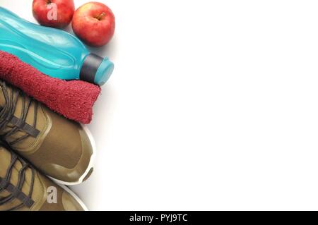 Attributes of a healthy lifestyle: food, sports and athlete's equipment on white background. Flat view with copy space. Sneakers, towel, eco bottle Stock Photo
