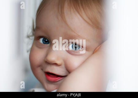 close-up portrait of a handsome little boy of one year old with blue eyes and blond hair Stock Photo