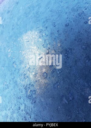Frost pattern on Frozen covered Glass with Light Reflection Stock Photo