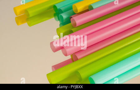 Multicoloured plastic straws on a mirrored surface Stock Photo
