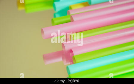 Multicoloured plastic straws on a mirrored surface Stock Photo
