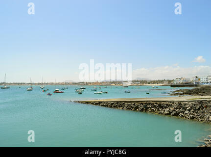 Fishing boats in Corralejo harbour with a slipway for entering and leav Stock Photo