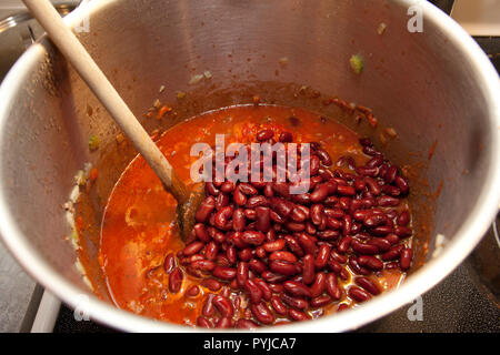 Huge pot of chili cooking on the stovetop in a metal vat Stock Photo