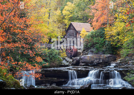 The old grist mill at Babcock State Park in West Virginia, lies nestled within a curtain of vivid autumn foliage above the scenic Glade Creek. Stock Photo