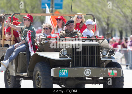 Chicago, Illinois, USA - May 5, 2018: The Polish Constitution Day Parade, Polish men wearing world war two military uniforms riding a truck during the Stock Photo