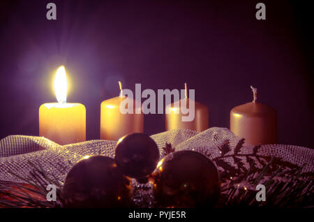 advent wreath with one burning candle against purple background Stock Photo