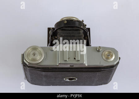 overhead view and slightly from behind of a 120mm film camera with a folding bellow lens Stock Photo