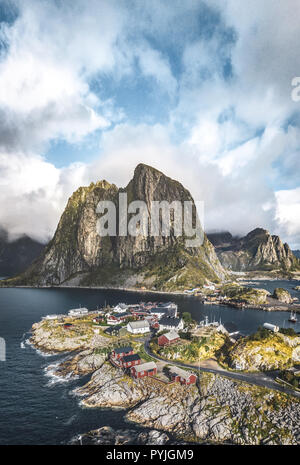 Panorama of famous tourist attraction Hamnoy fishing village on Lofoten Islands near Reine, Norway with red rorbu houses in autumn with clouds and blu Stock Photo