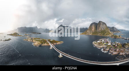 Aerial panoramic view of Reine traditional fishing village in the Lofoten archipelago in northen Norway with blue sea and mountains during sunny arcti Stock Photo