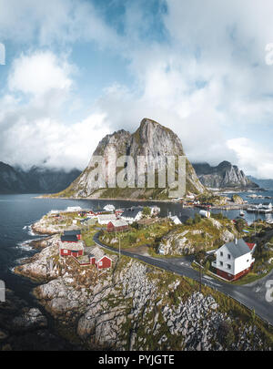 Panorama of famous tourist attraction Hamnoy fishing village on Lofoten Islands near Reine, Norway with red rorbu houses in autumn with clouds and blu Stock Photo