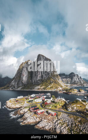 Panorama of famous tourist attraction Hamnoy fishing village on Lofoten Islands near Reine, Norway with red rorbu houses in autumn with clouds and blu Stock Photo