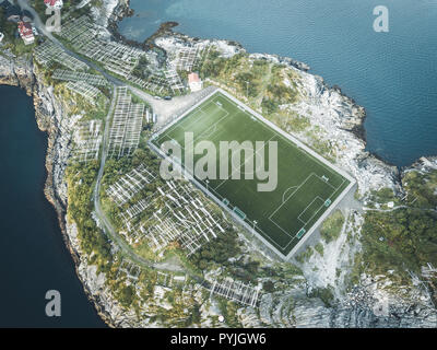 Football field stadium in Henningsvaer from above. Henningsvaer is a fishing village near Reine and Hamboy located on several small islands in the Lof Stock Photo