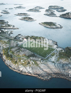 Football field stadium in Henningsvaer from above. Henningsvaer is a fishing village near Reine and Hamboy located on several small islands in the Lof Stock Photo